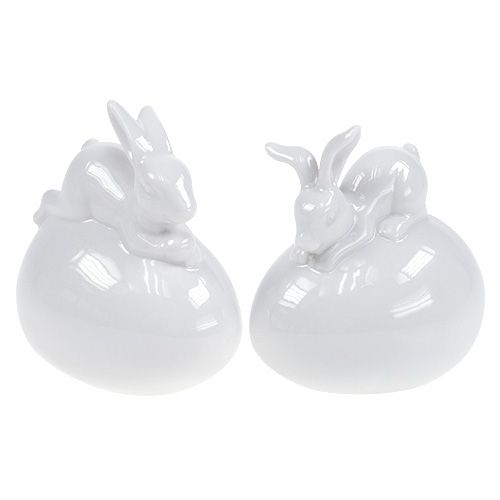 Floristik24 Figurine décorative lapin sur blanc d&#39;oeuf 8.5cm 2pcs