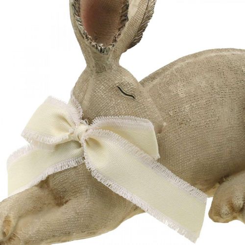 Floristik24 Lapin de Pâques couché avec noeud Décoration de Pâques en polyrésine 28cm