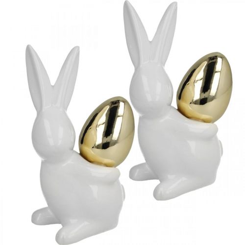 Article Lapins avec oeuf d&#39;or, lapins en céramique pour Pâques blanc noble, doré H13cm 2pcs